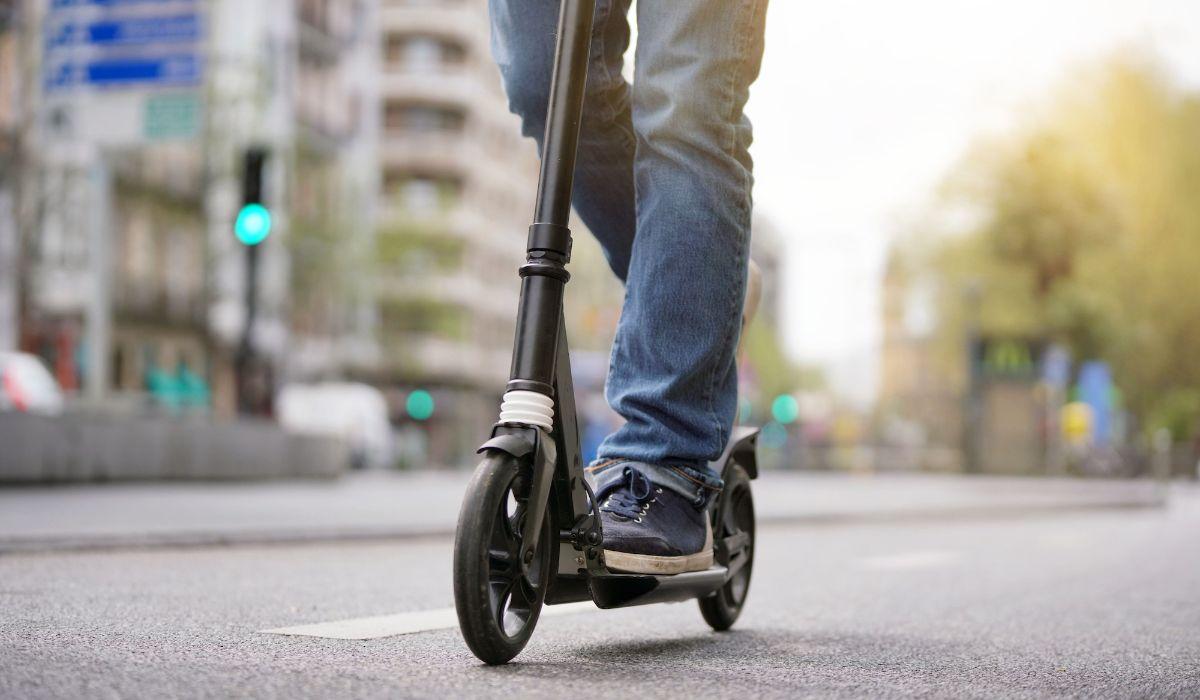 Man riding a microscooter on a main road .jpg