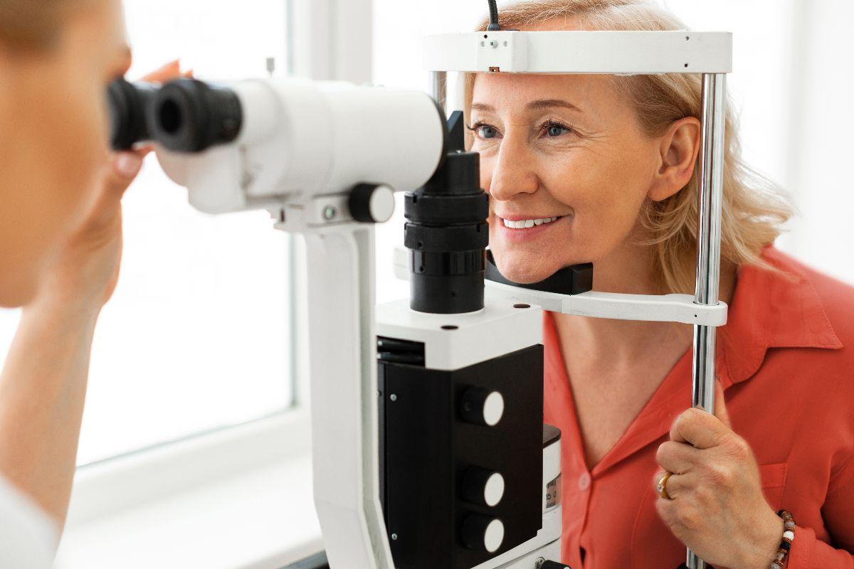woman placing her chin on a stand while doctor observing her eyes.jpg