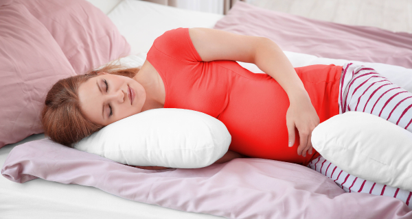 Pregnant woman sleeping with pillows